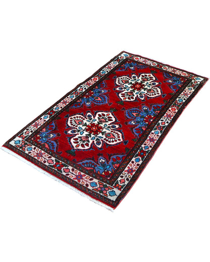 Tappeto Hamedan persiano 167x100 cm annodato a mano, fondo rosso con motivi floreali avorio e dettagli blu, design tradizionale con medaglioni simmetrici