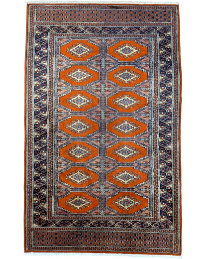 Tappeto Bokhara 151x95 cm annodato a mano, fondo arancio con medaglioni geometrici ripetuti e dettagli beige e blu